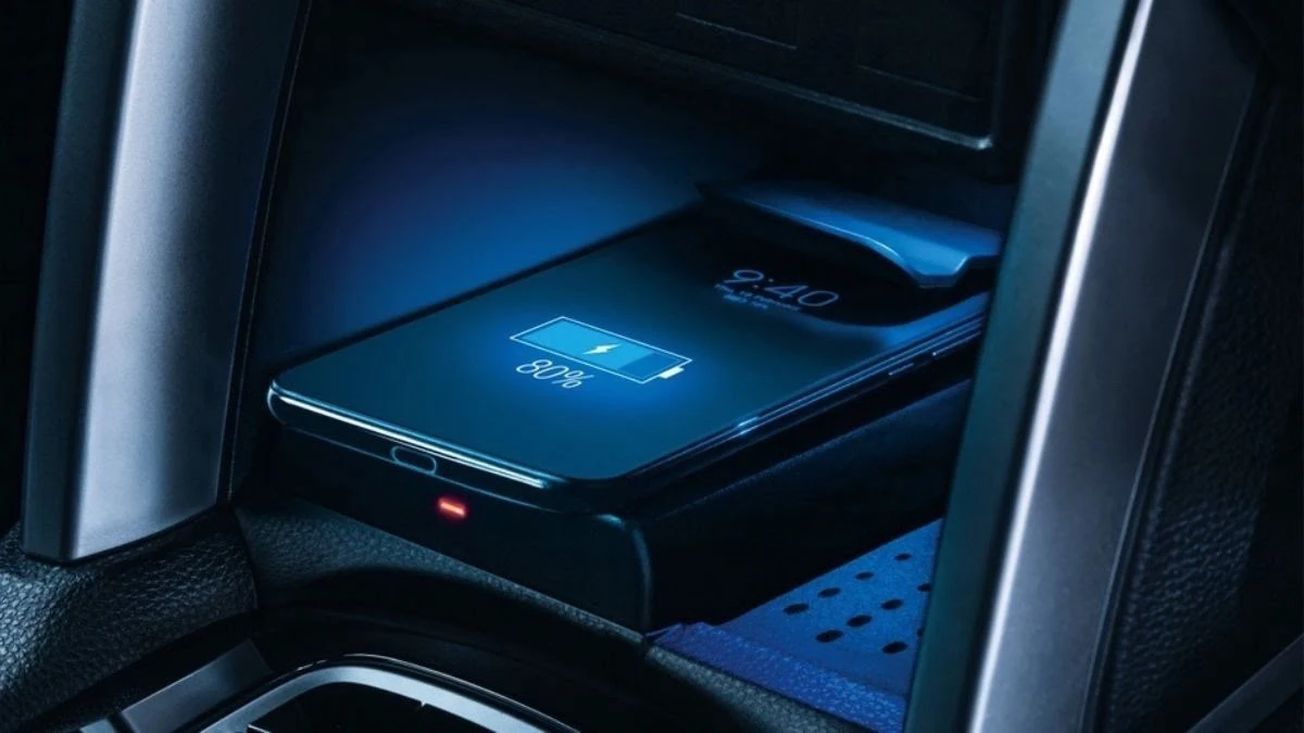 Toyota Corolla Cross wireless phone charging pad showing smartphone with battery indicator in center console