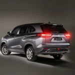 Rear three-quarter view of Toyota Innova Zenix with illuminated LED taillights and modern styling