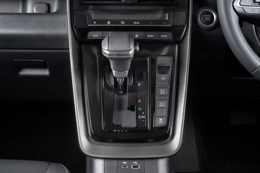 Center console of Toyota Innova Zenix featuring shifter assembly and integrated comfort control functions