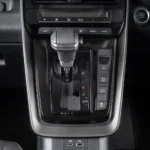 Center console of Toyota Innova Zenix featuring shifter assembly and integrated comfort control functions