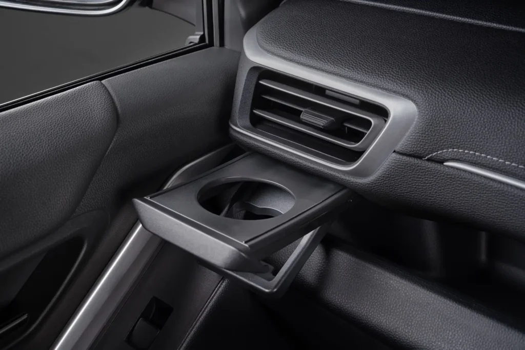Toyota Innova Zenix rear air conditioning vents with fold-down cup holder for passenger comfort amenities