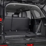 Spacious trunk area of Toyota Innova Zenix with open tailgate showing practical loading space accessibility