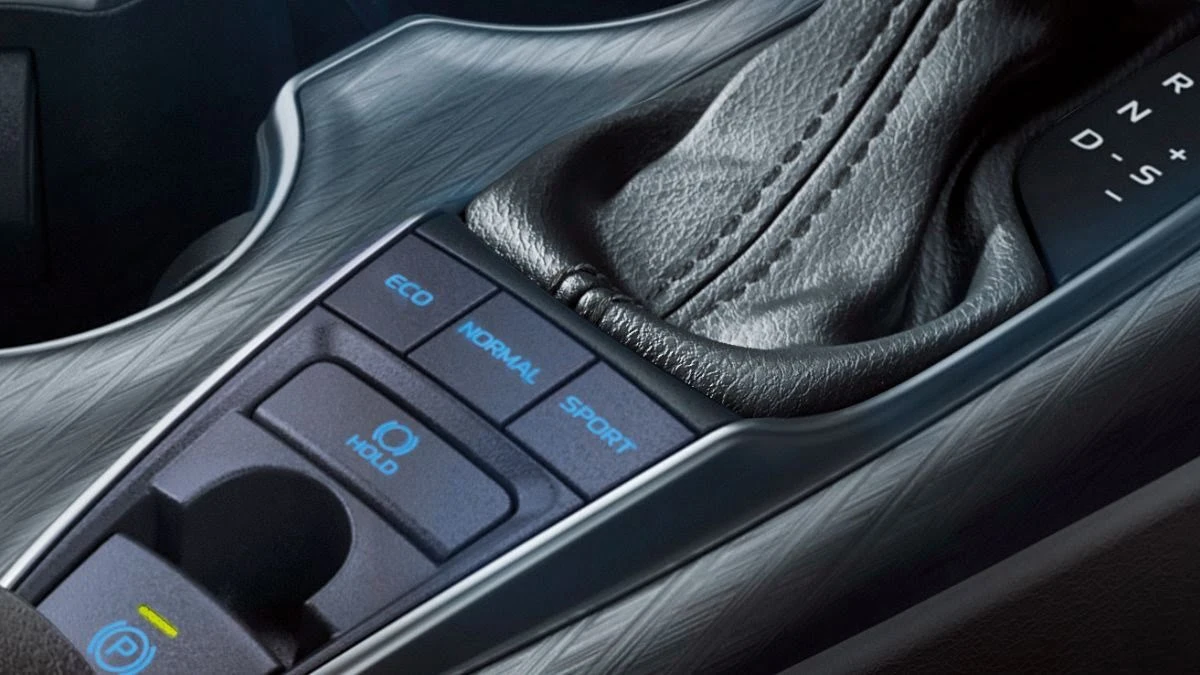 Close-up of Toyota Camry driving mode selector controls featuring illuminated ECO, Normal, Sport settings