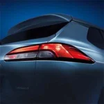 Close-up of Toyota Corolla Cross Hybrid Electric LED headlight featuring blue accent lighting and modern design