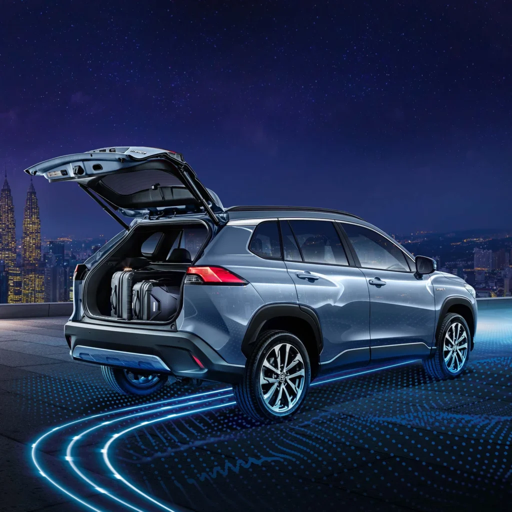 Toyota Corolla Cross Hybrid Electric with open tailgate showing cargo space against Kuala Lumpur city skyline