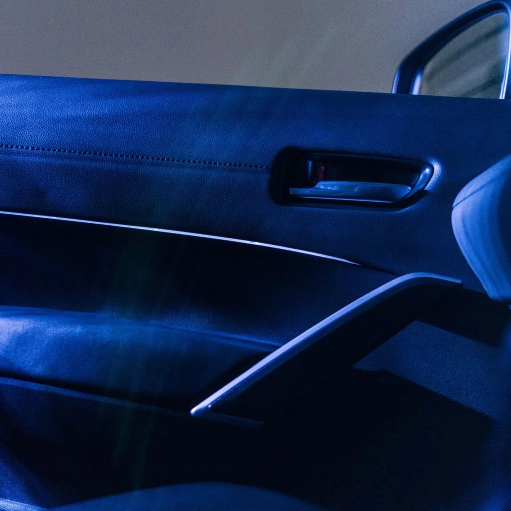 Interior door handle of Toyota Corolla Cross Hybrid Electric with illuminated accent lighting and premium interior trim