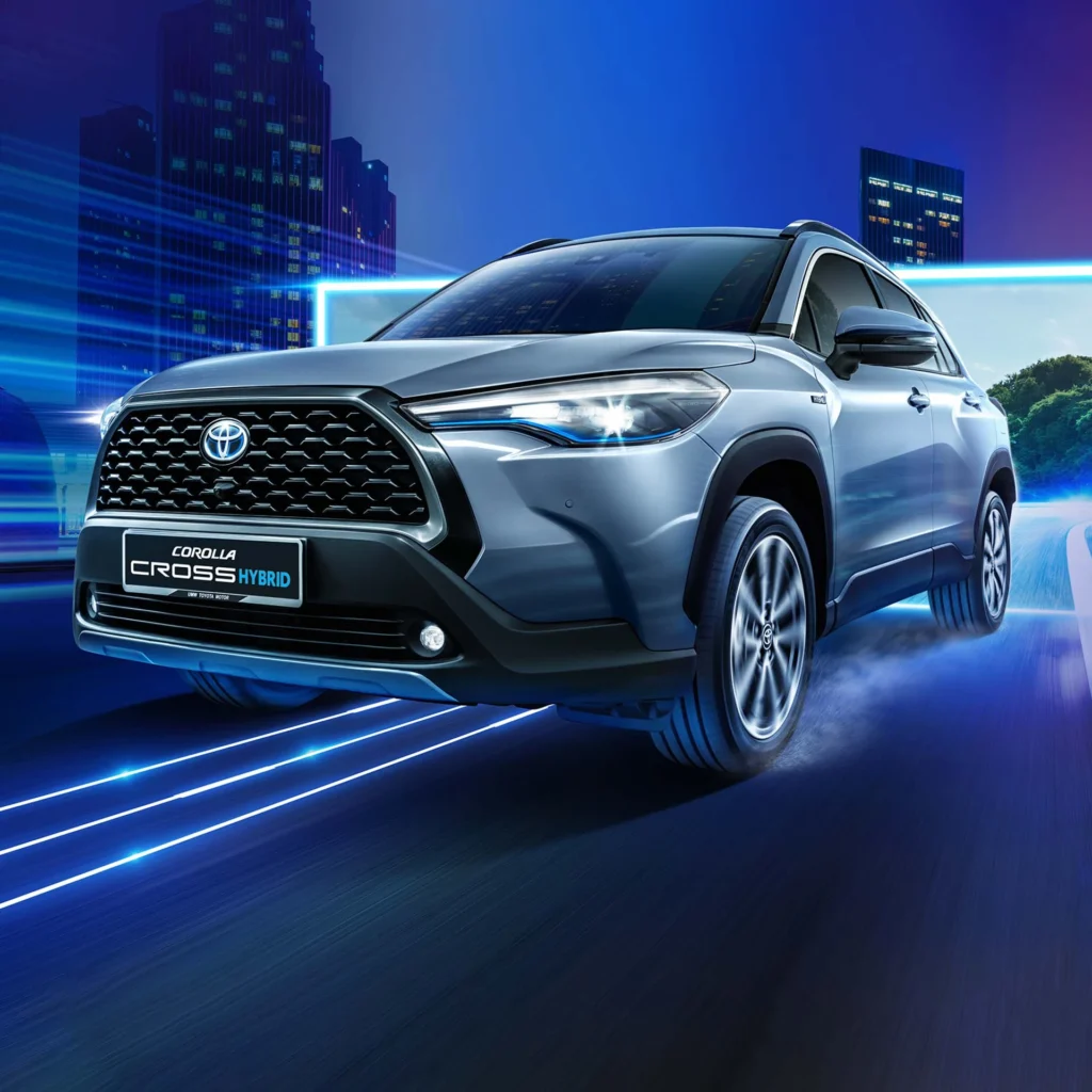 Toyota Corolla Cross Hybrid Electric positioned against modern cityscape with motion blur and light effects
