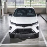 White Toyota Fortuner SUV front view parked in modern underground garage