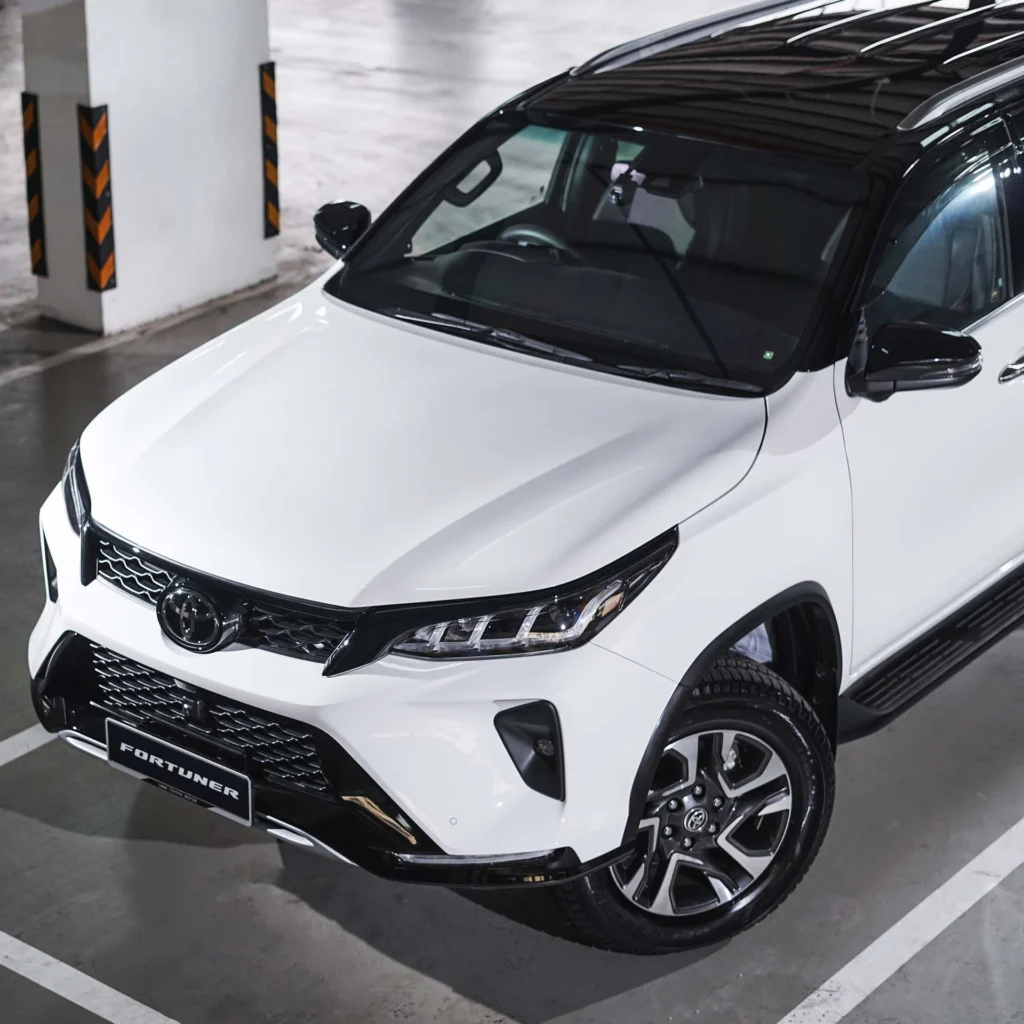 White Toyota Fortuner showcasing modern design elements and robust build quality in covered parking facility