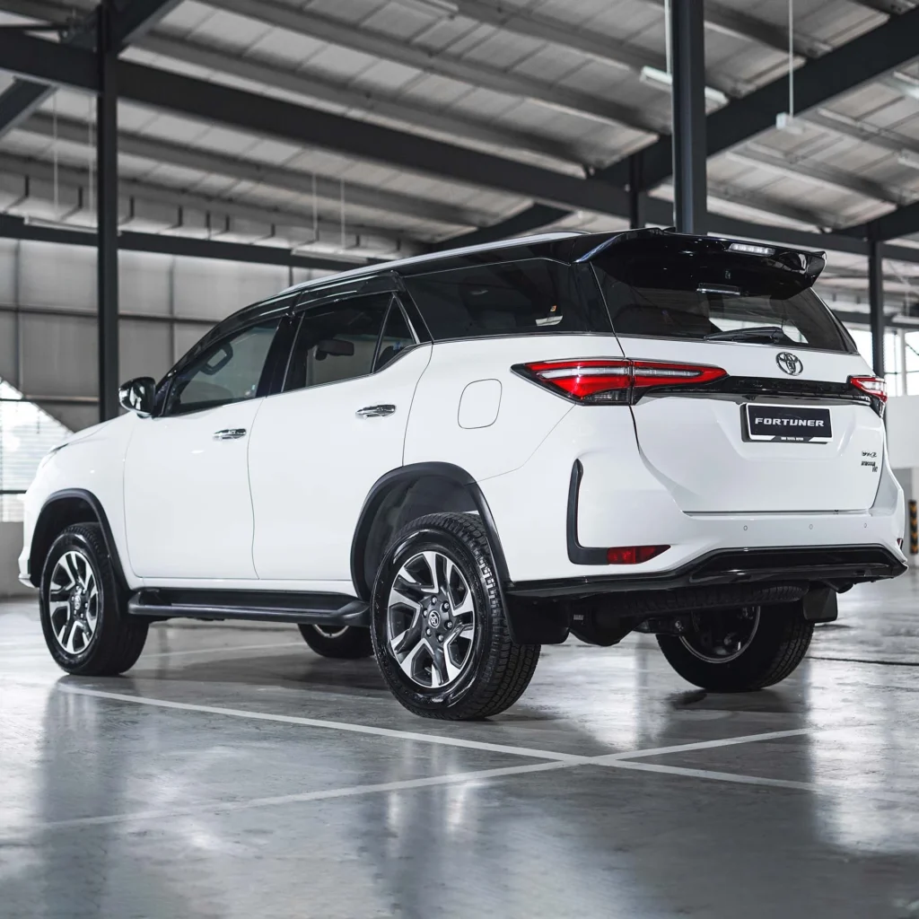 Toyota Fortuner SUV positioned in modern garage showing sleek profile and contemporary taillight design
