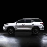 Toyota Fortuner positioned against dark background highlighting sleek body lines