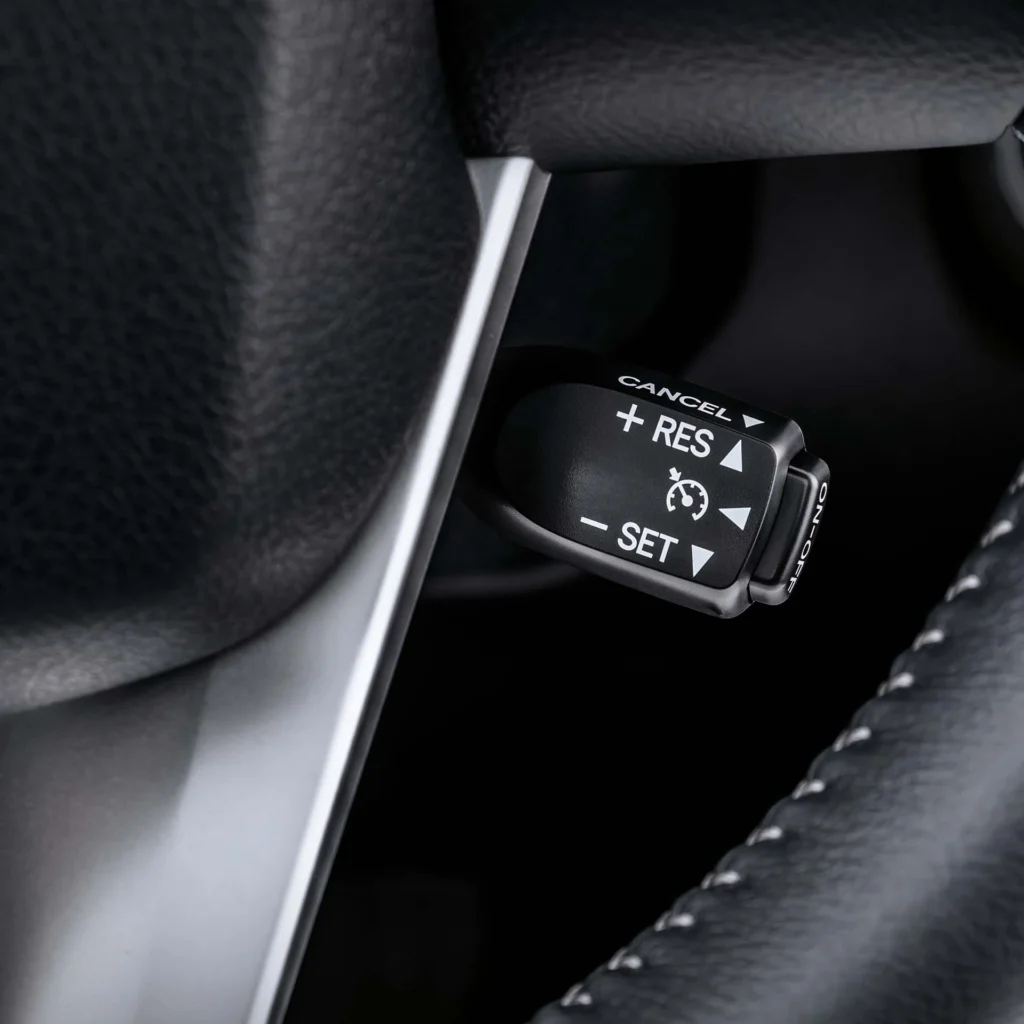 Close-up of Toyota Fortuner cruise control interface with ergonomic button layout and premium steering wheel design