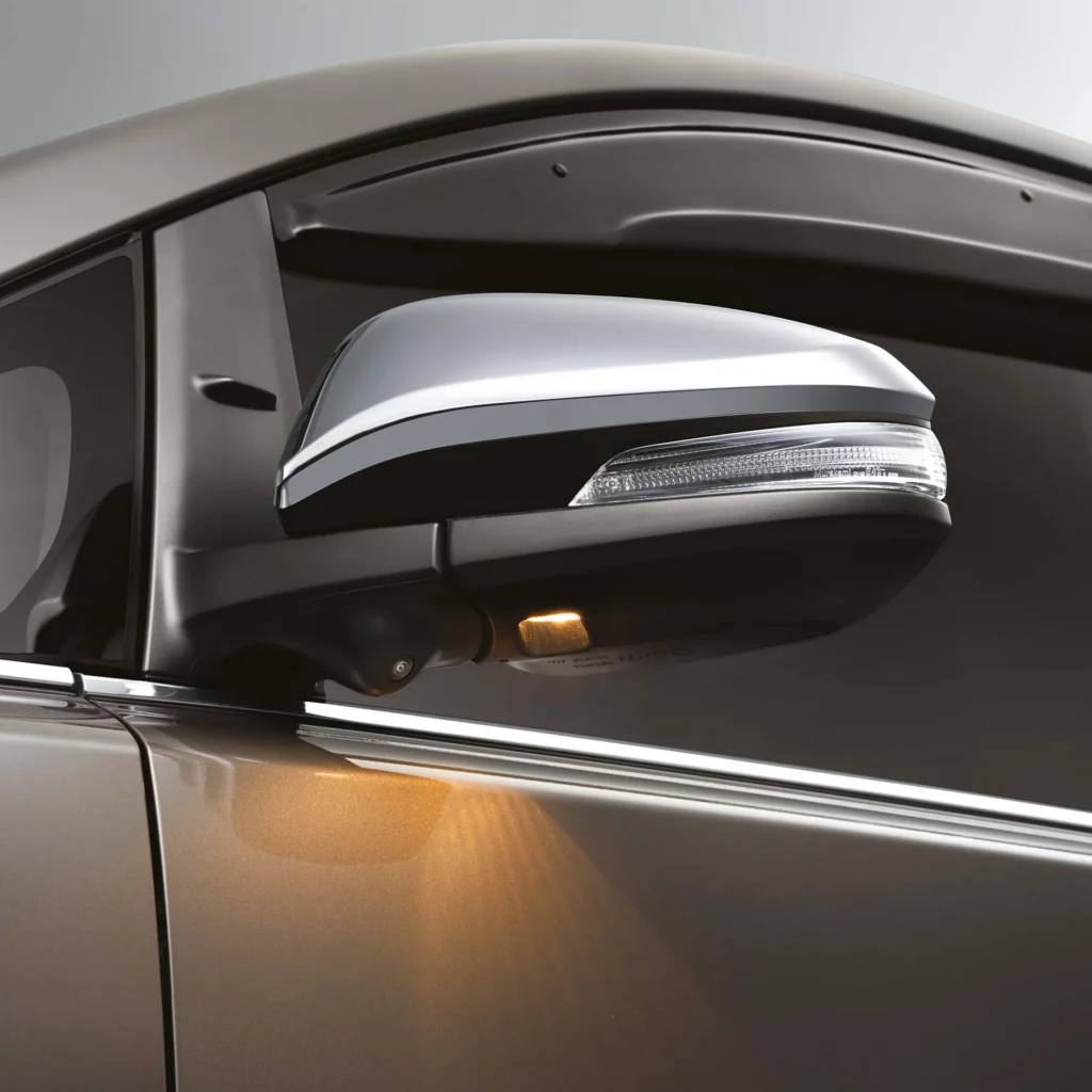 Toyota Innova side mirror with integrated turn signal and chrome accent for enhanced visibility and style