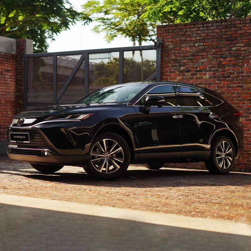 Toyota Harrier front exterior with distinctive grille design and chrome accents against brick wall background