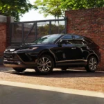 Toyota Harrier front exterior with distinctive grille design and chrome accents against brick wall background