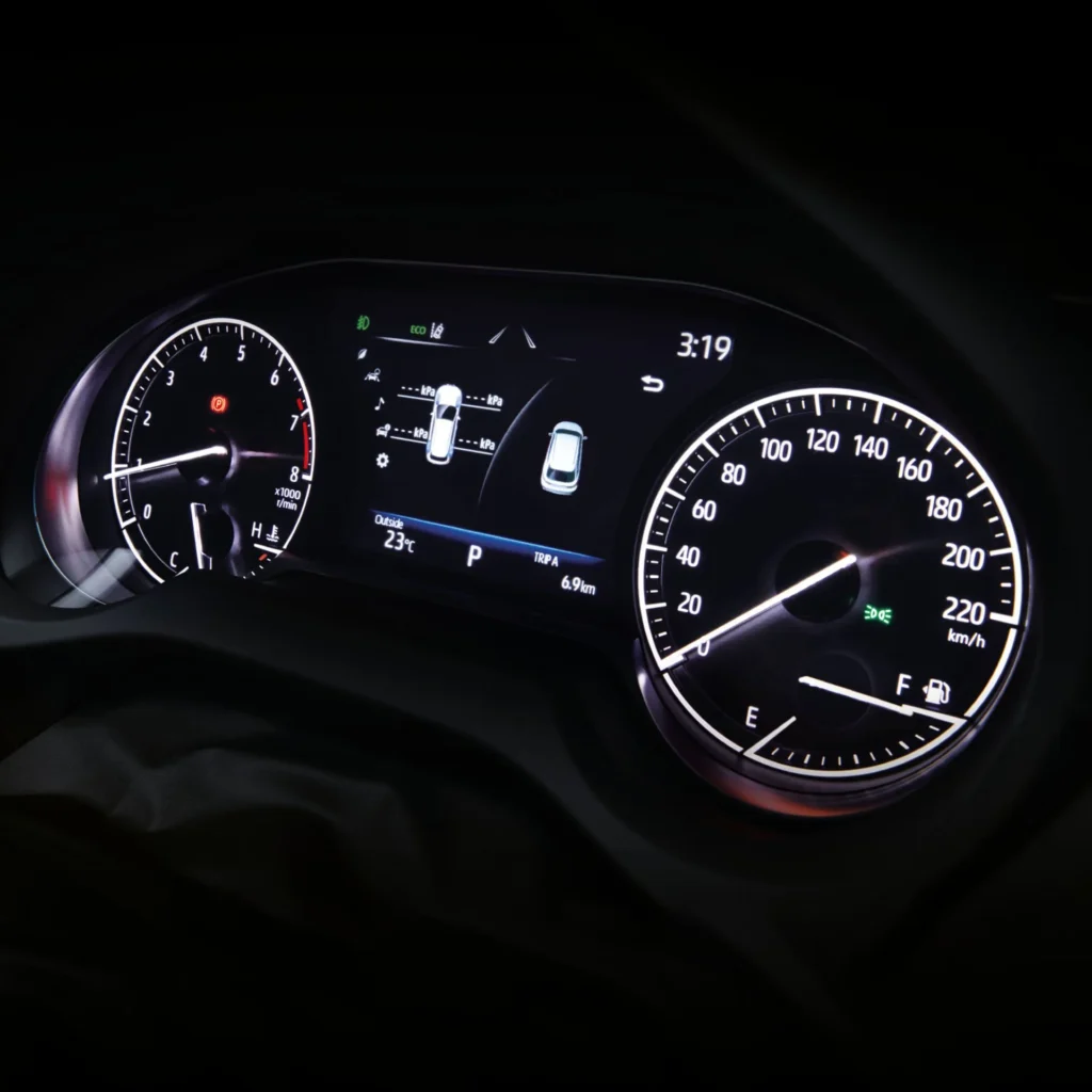 Toyota Harrier instrument cluster displaying speedometer, tachometer, and digital information screen with vehicle status