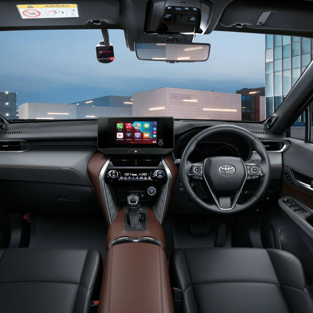 Toyota Harrier interior dashboard with touchscreen infotainment system and brown leather trim in urban setting
