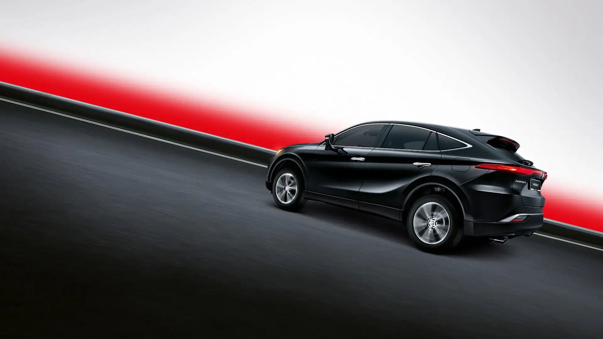 Black Toyota Harrier SUV driving on curved road with dramatic red lighting and modern sporty design profile