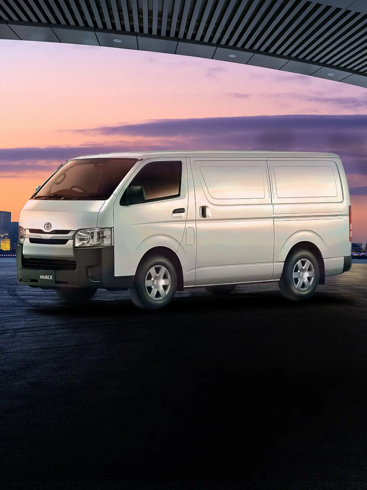 White Toyota Hiace van parked at waterfront with dramatic sunset sky