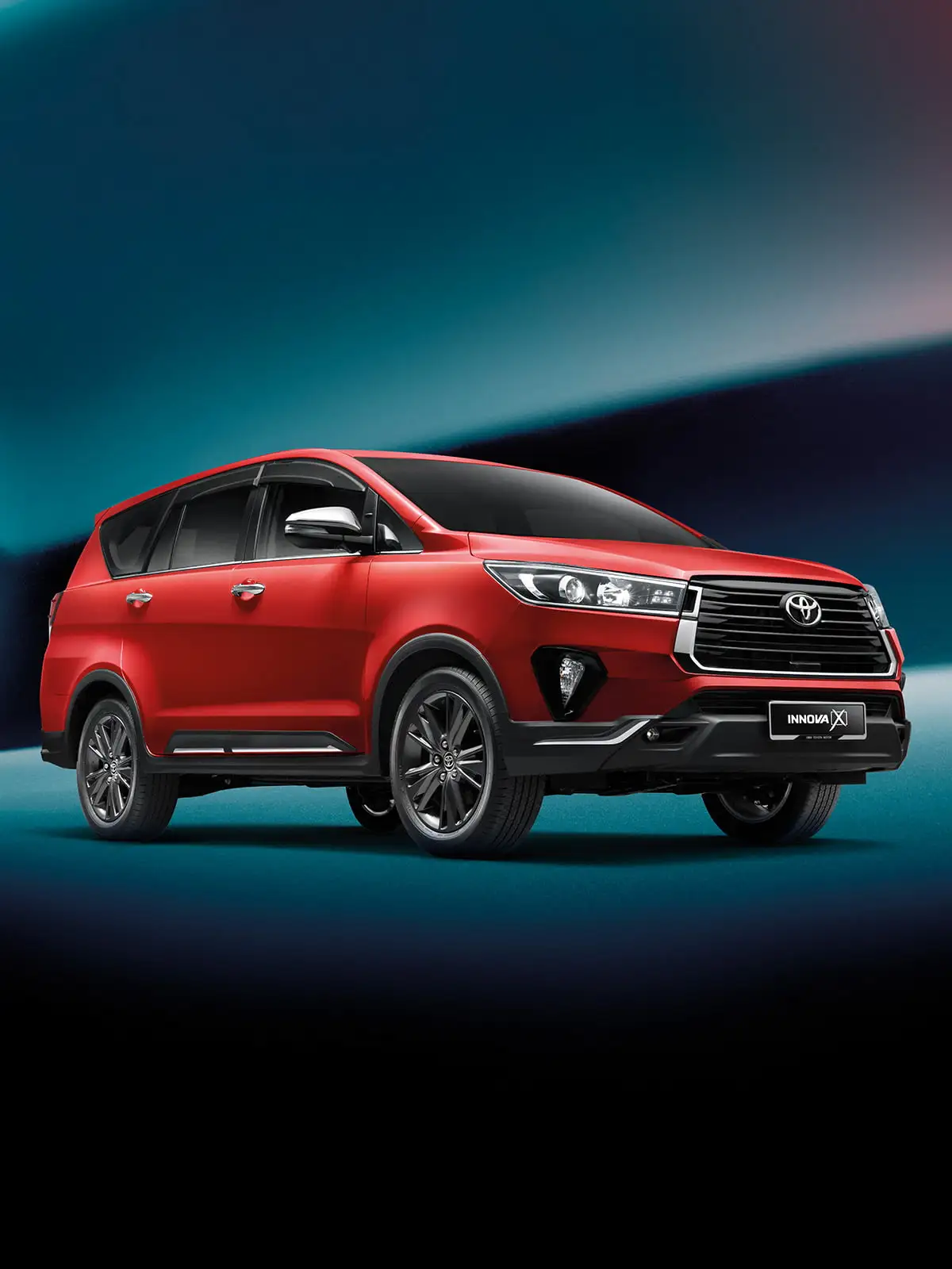 Red Toyota Innova with modern design featuring chrome grille and alloy wheels on dynamic blue background