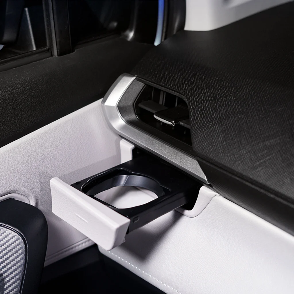 Car interior cup holder detail in Toyota Veloz showing practical storage solutions and modern design elements